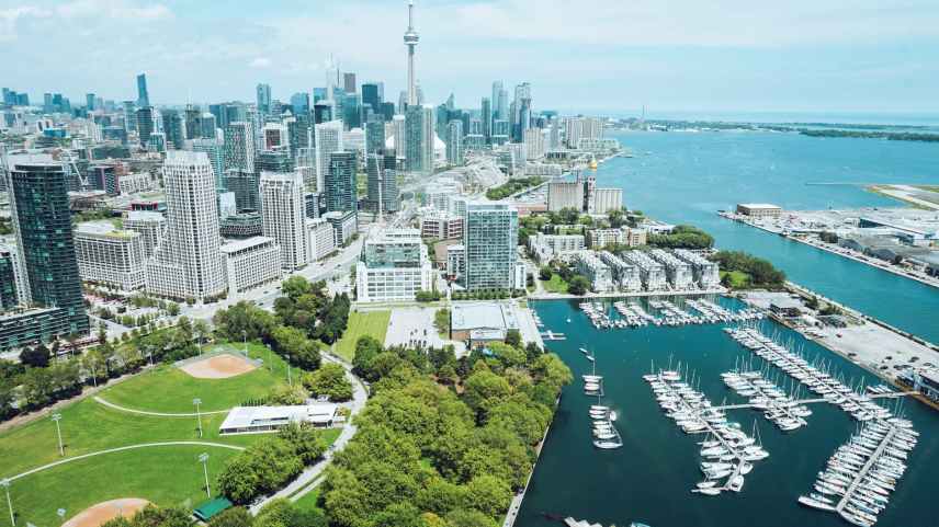 architecture and harbor with moored boats of contemporary coastal city